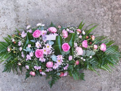 Pink colour casket spray,roses,chrysanthemums,