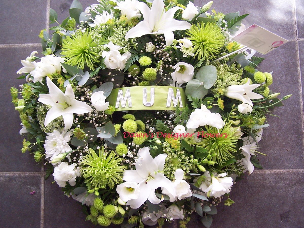 Green and white funeral wreath by Dawn's Designer Flowers