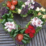 Heart tribute in lilac,orange and cream, from orchids,roses,trachelium